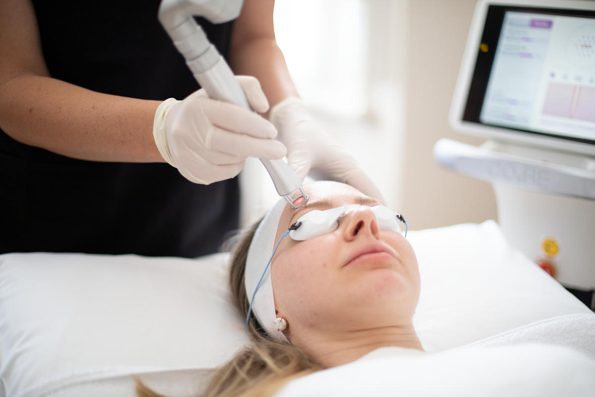 Woman receiving laser treatment with the CORE laser.