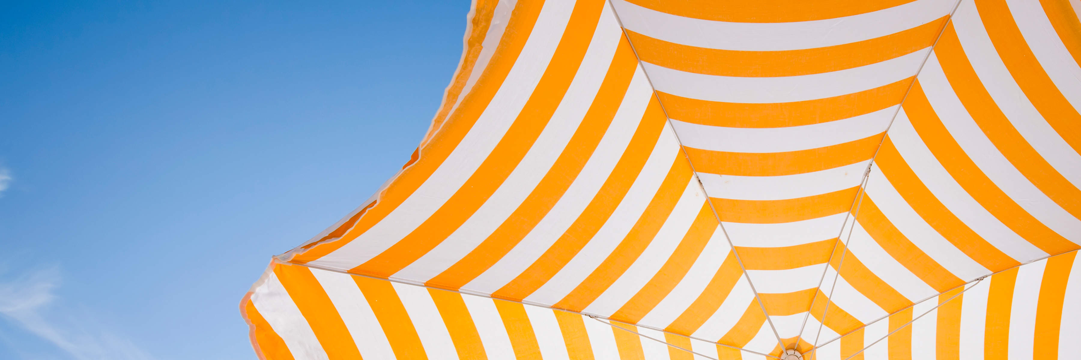 Yellow and white striped sun umbrella.
